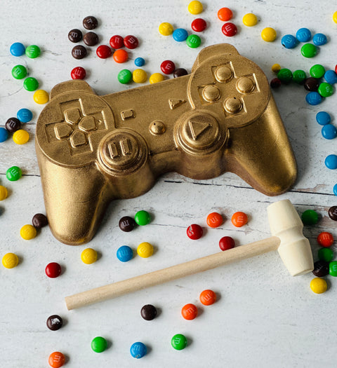 a video game controller next to some candy