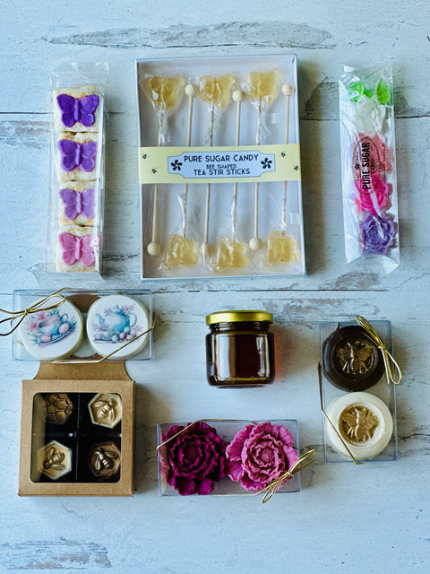 a box of cake pops, a jar of jam, and a box of cookies