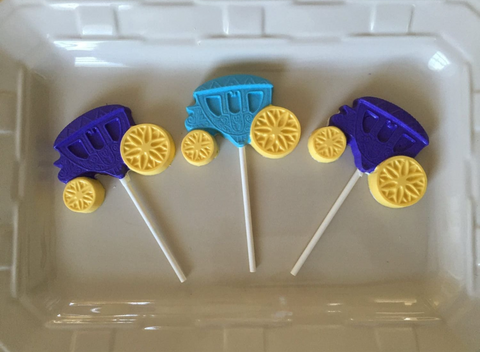 three lollipops with yellow and blue candies on them