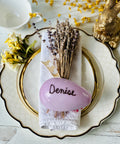 a place setting with flowers and a napkin