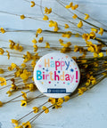 a button that says happy birthday surrounded by yellow flowers