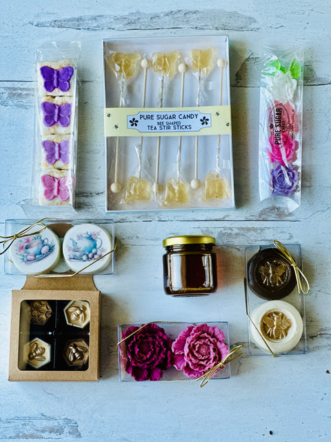 a box of cake pops, a jar of jam, and a box of cookies