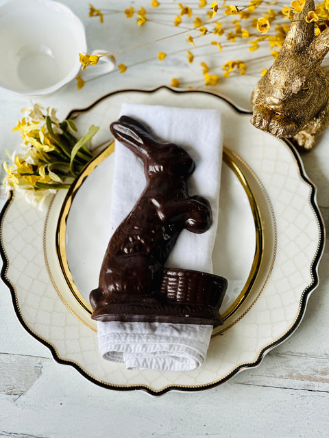 a chocolate bunny sitting on top of a white plate