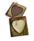 a couple of heart shaped chocolates in a box