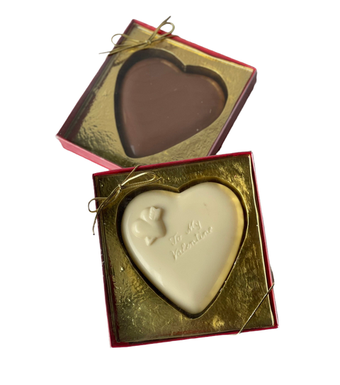 a couple of heart shaped chocolates in a box