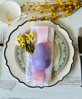 a plate with a purple egg on it