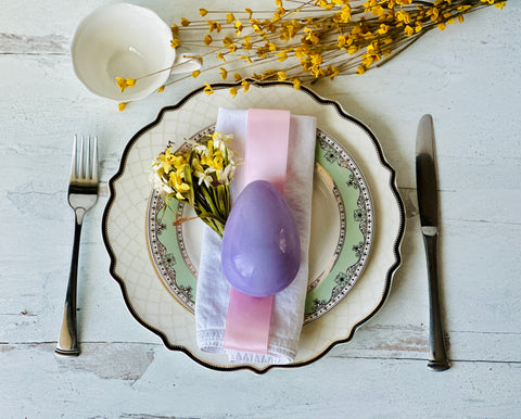 a plate with a purple egg on it