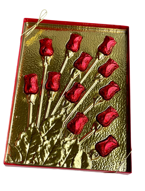 a close up of a metal object with red flowers on it